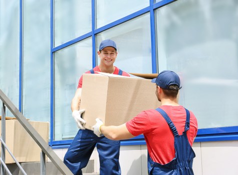 A local man and van service helping with a Pimlico move outside a period-style London building
