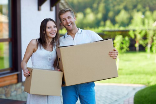 Professional movers handling furniture in a central London apartment block
