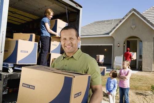 Moving crew handling office items in a central London business property